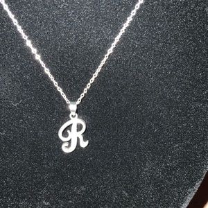 Silver R initial pendant necklace.